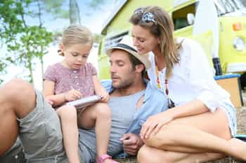 Family playing with video game on campground